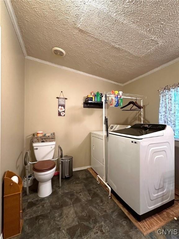 laundry room with washer and dryer, crown molding, and a textured ceiling