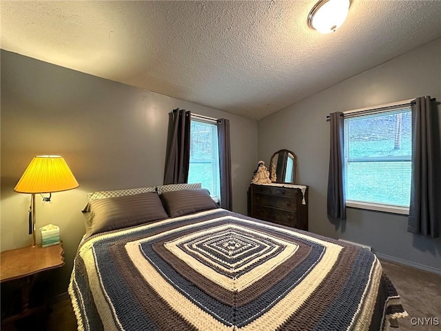 bedroom with carpet, a textured ceiling, and vaulted ceiling