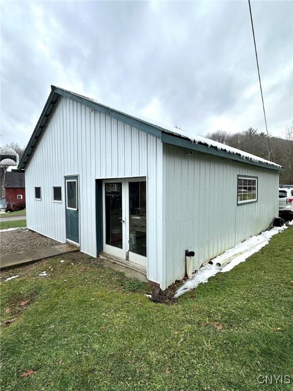 view of property exterior featuring a lawn