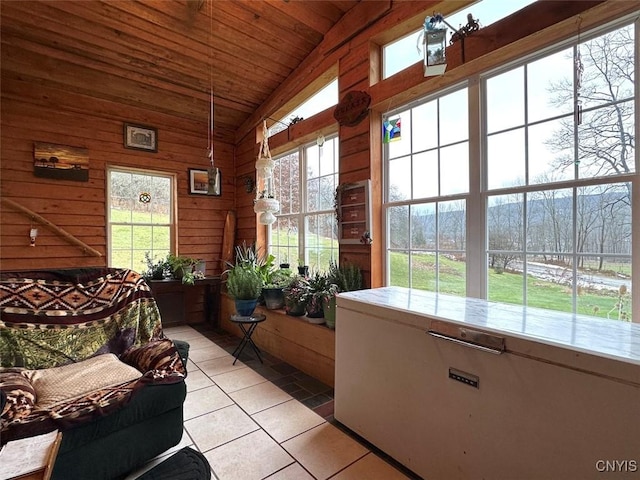 sunroom / solarium with plenty of natural light, wooden ceiling, and vaulted ceiling