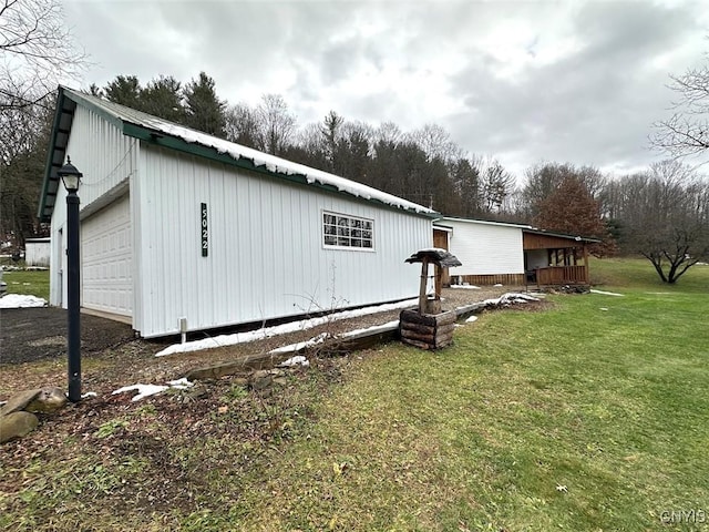 view of home's exterior with a lawn, an outbuilding, and a garage