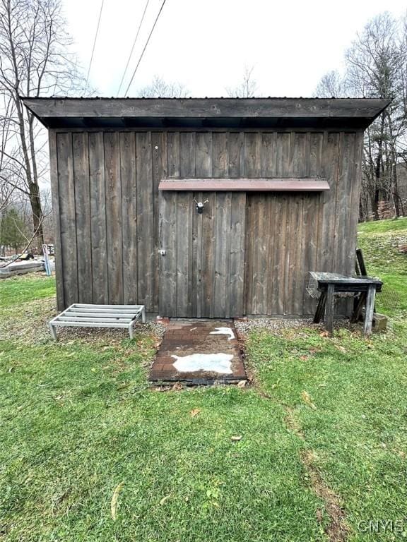 view of outbuilding with a lawn