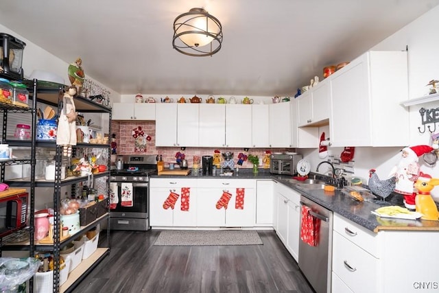 kitchen featuring white cabinets, dark wood-type flooring, and appliances with stainless steel finishes