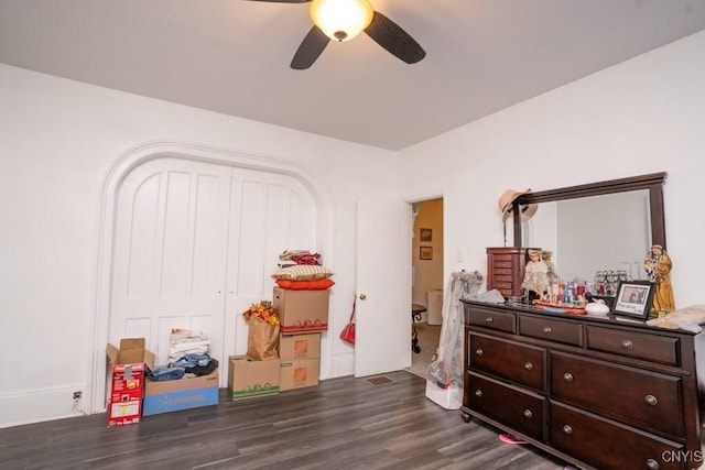 bedroom with dark hardwood / wood-style flooring, a closet, and ceiling fan