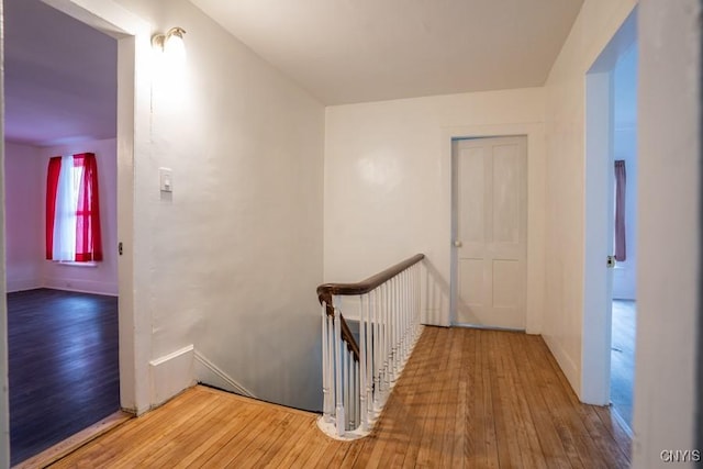 corridor with hardwood / wood-style flooring