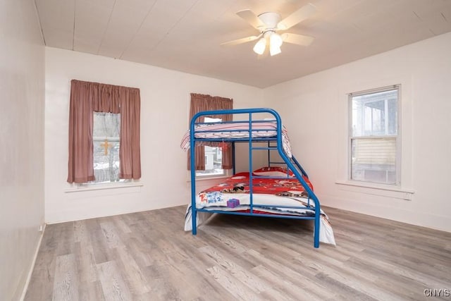 bedroom with ceiling fan and hardwood / wood-style flooring