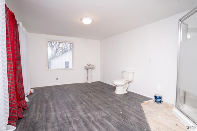 bathroom with toilet and wood-type flooring