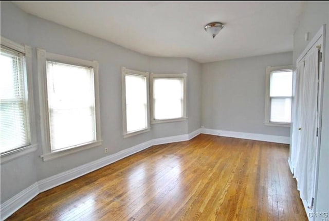 unfurnished room featuring light hardwood / wood-style floors and a wealth of natural light