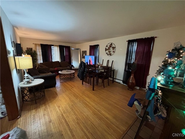 living room featuring baseboard heating and light hardwood / wood-style flooring