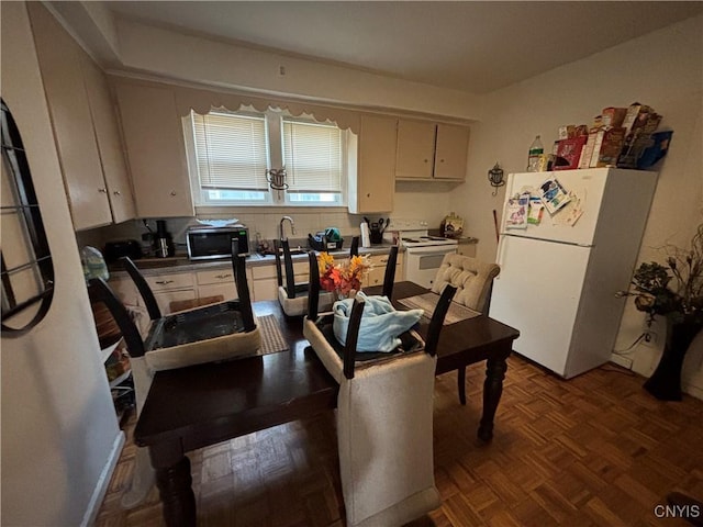 dining space with parquet flooring