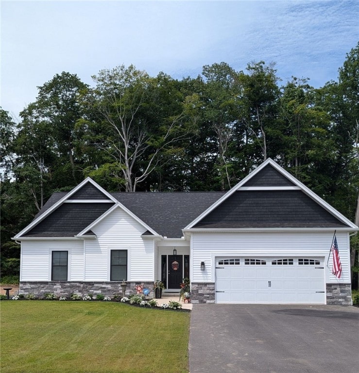 view of front of property featuring a garage and a front lawn