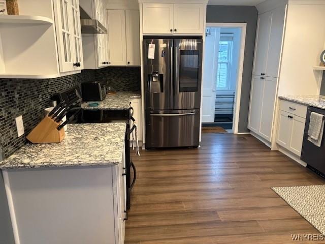 kitchen featuring stainless steel fridge, wall chimney exhaust hood, dark hardwood / wood-style floors, white cabinetry, and range with electric stovetop