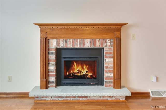 interior details featuring wood-type flooring and a fireplace