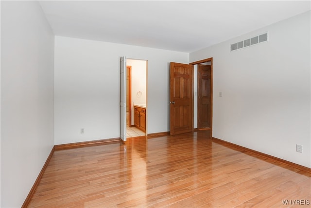 spare room with light hardwood / wood-style floors