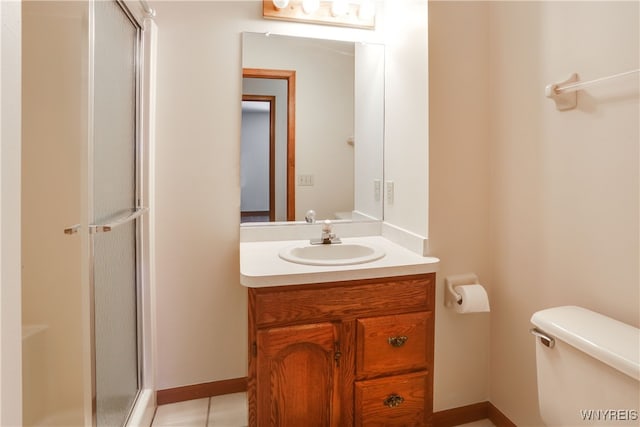 bathroom with tile patterned floors, walk in shower, vanity, and toilet