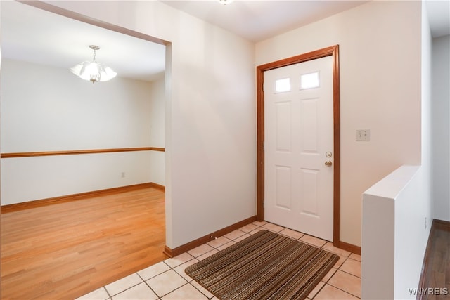 entryway featuring a chandelier and light hardwood / wood-style flooring