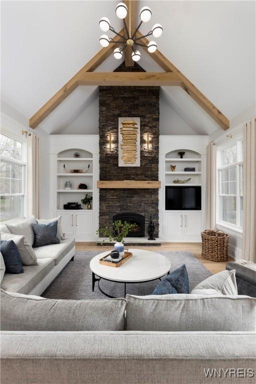 living room featuring beam ceiling, ceiling fan, high vaulted ceiling, a fireplace, and hardwood / wood-style flooring