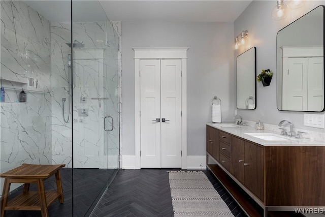 bathroom with a tile shower, vanity, and parquet flooring