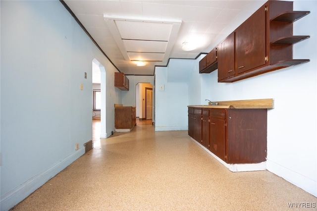 kitchen with dark brown cabinetry and sink