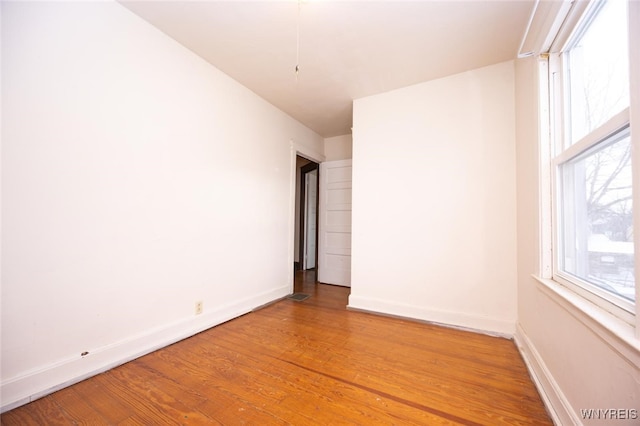 empty room with hardwood / wood-style flooring