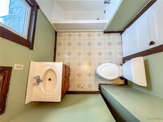 bathroom with vanity and tile walls