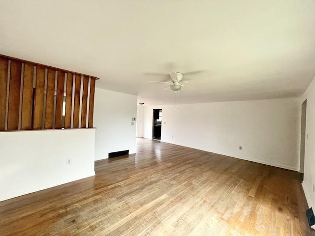 unfurnished living room with ceiling fan and hardwood / wood-style floors