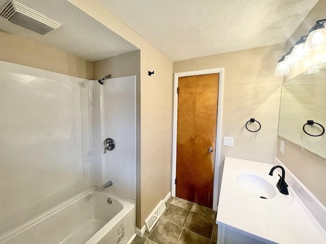 bathroom with tile patterned flooring, vanity, and bathing tub / shower combination