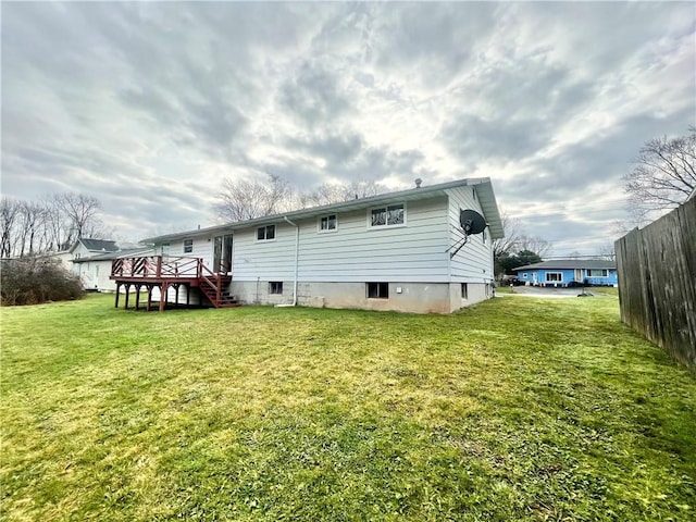 back of house featuring a yard and a wooden deck