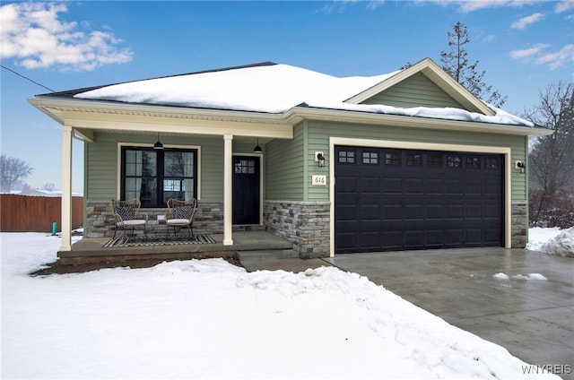 view of front of home featuring a porch and a garage