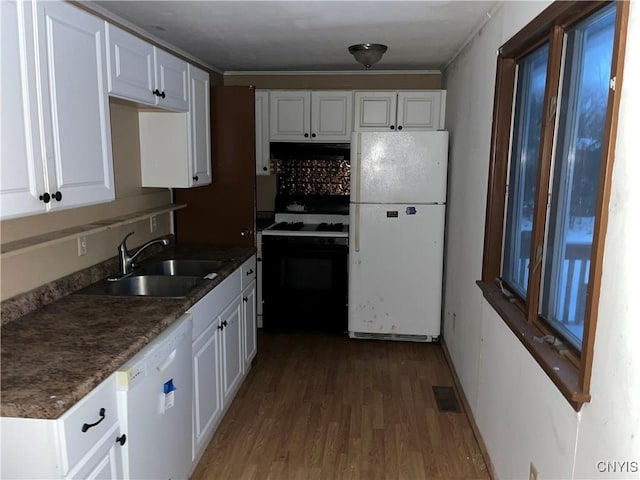 kitchen featuring white cabinets, white appliances, sink, and hardwood / wood-style flooring