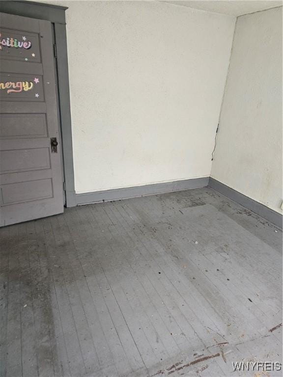 interior space with baseboards and wood finished floors