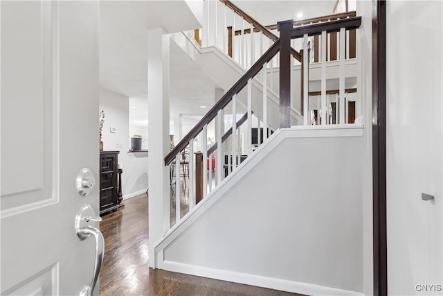 stairs featuring wood-type flooring