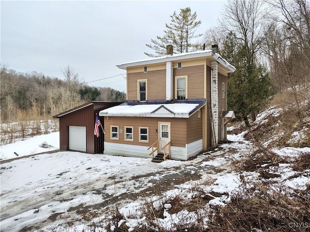 view of front of home featuring a garage and an outdoor structure