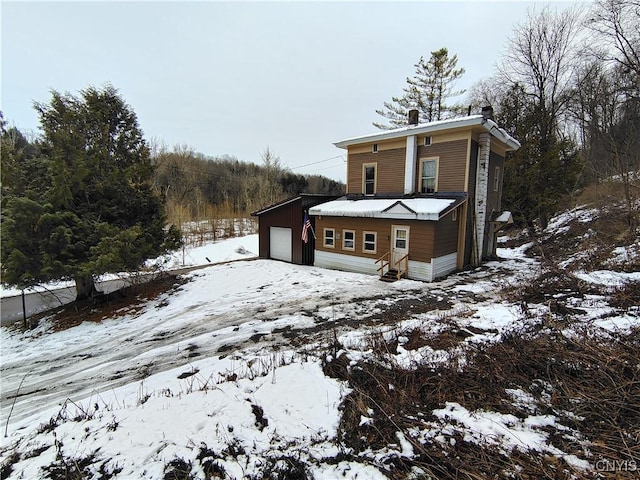 view of front of home featuring a garage and an outdoor structure