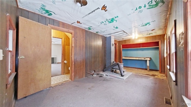 interior space with wood walls and carpet floors