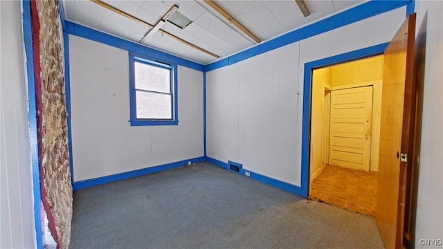 empty room featuring dark carpet