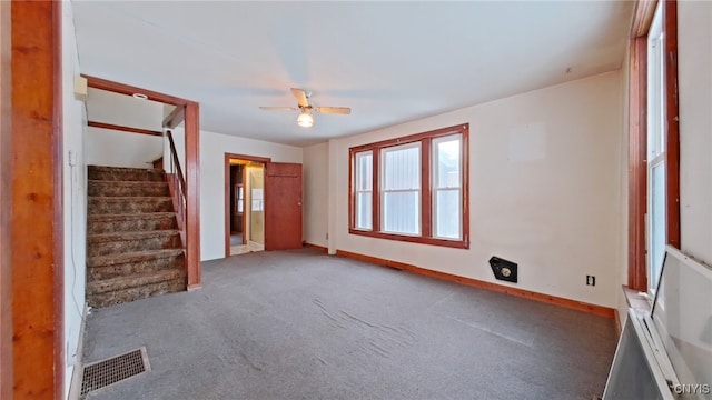 carpeted empty room featuring ceiling fan