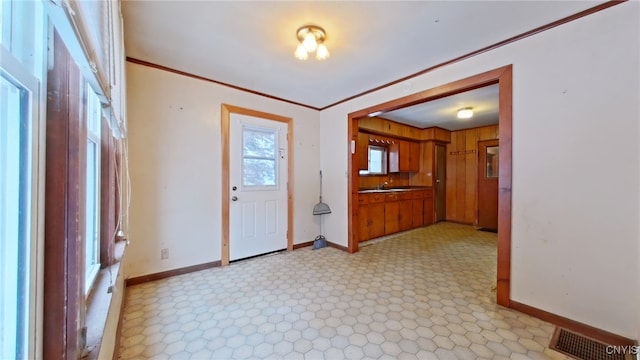 foyer featuring ornamental molding