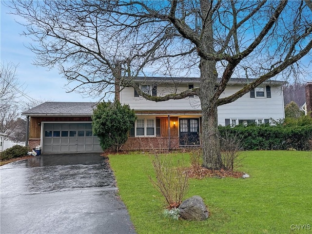 view of front of home with a front lawn and a garage