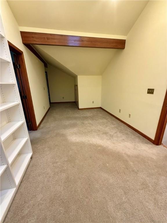 unfurnished room featuring light colored carpet and vaulted ceiling