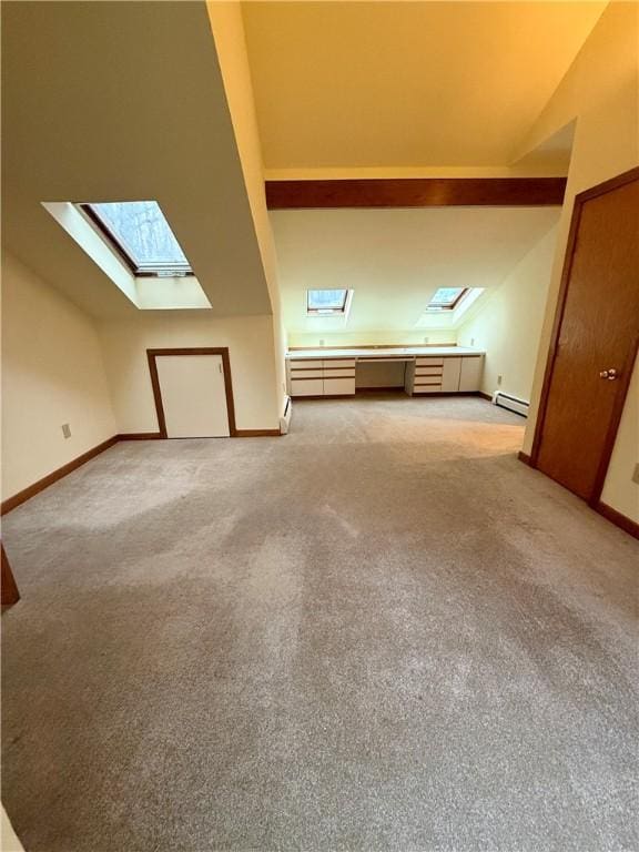 additional living space featuring baseboard heating, lofted ceiling with skylight, and light colored carpet