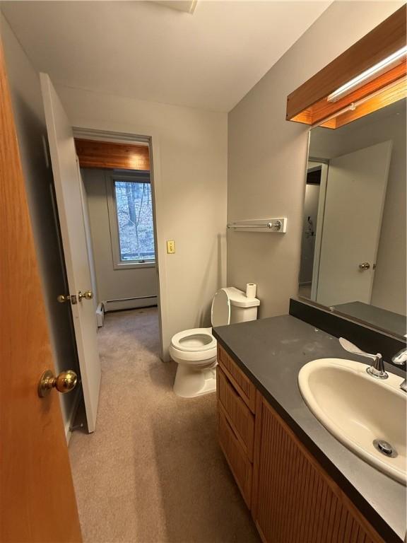 bathroom featuring vanity, a baseboard radiator, and toilet