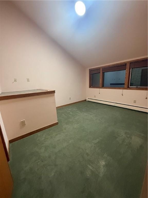 bonus room with dark colored carpet, baseboard heating, and vaulted ceiling