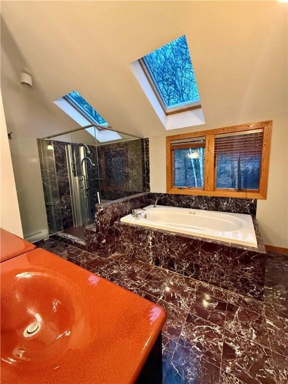 bathroom with separate shower and tub and lofted ceiling with skylight