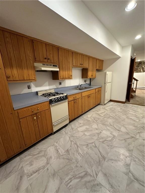 kitchen with white appliances, sink, and baseboard heating