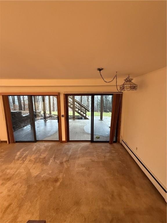 spare room featuring carpet and a baseboard radiator