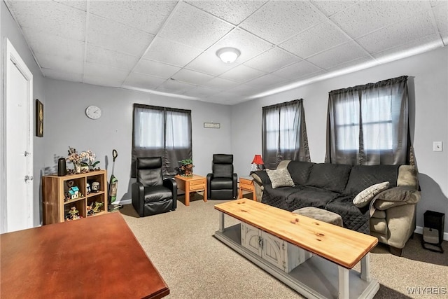 carpeted living room with a paneled ceiling and a healthy amount of sunlight