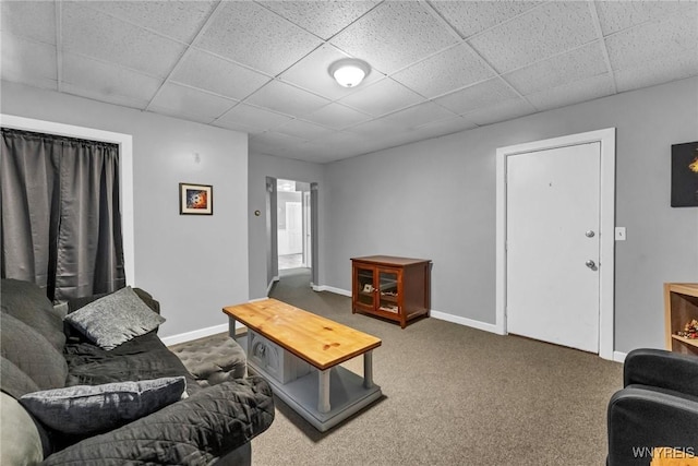 living room with carpet and a paneled ceiling