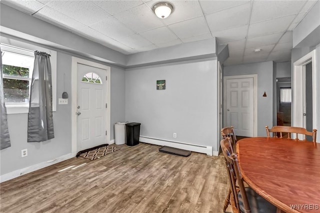 foyer with a paneled ceiling, wood-type flooring, and baseboard heating