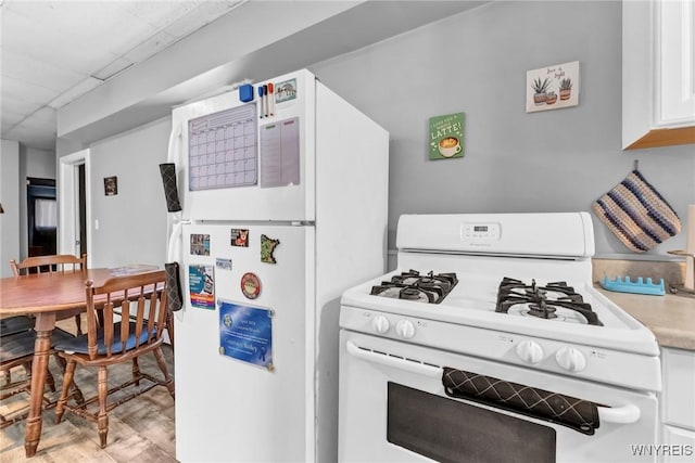 kitchen with white cabinets and white appliances